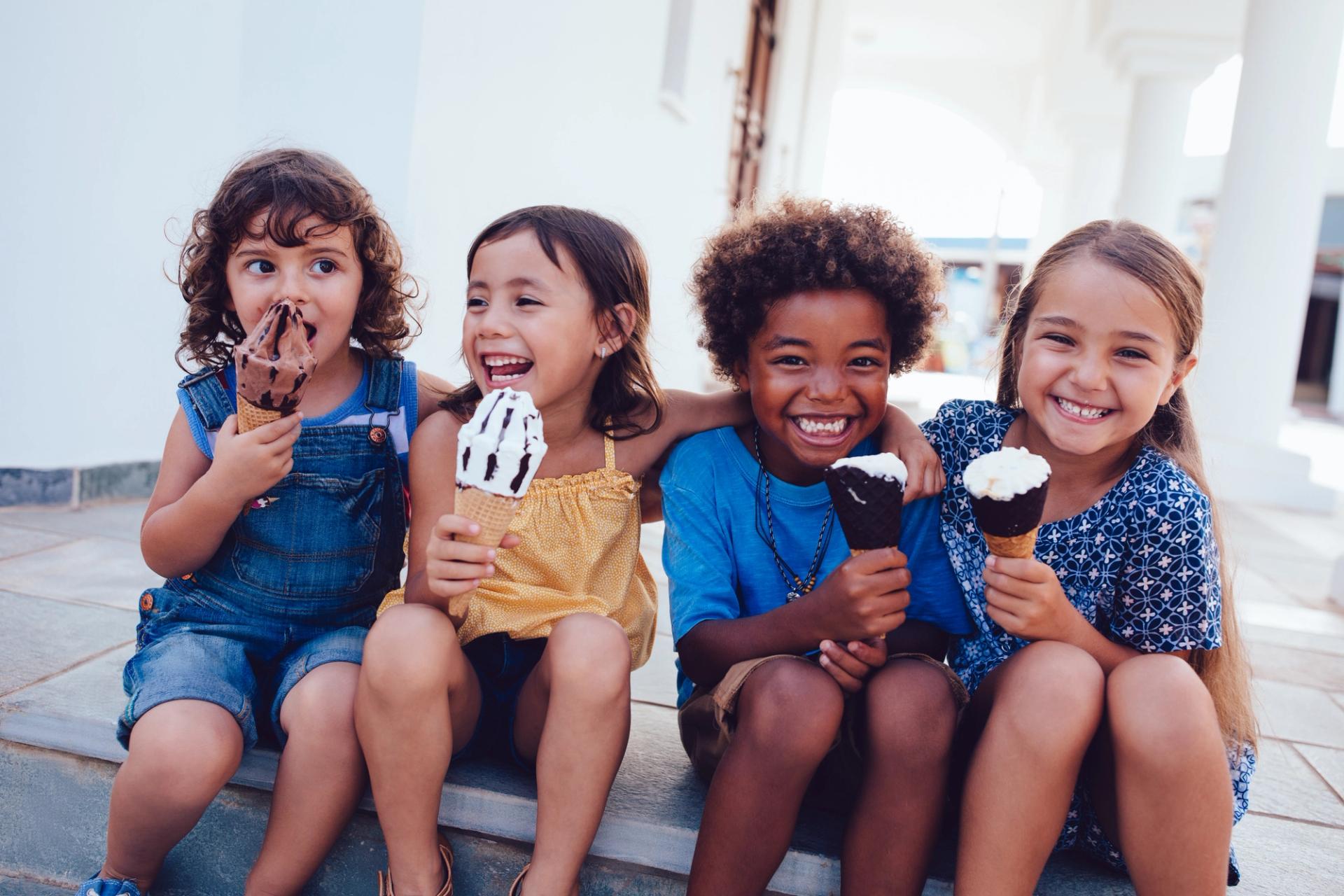 Children eating ice cream cones.