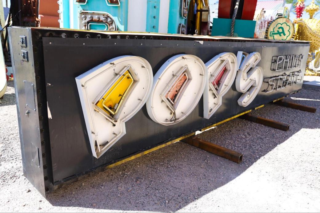 A black and white neon sign reads "POPS Philly Steaks"