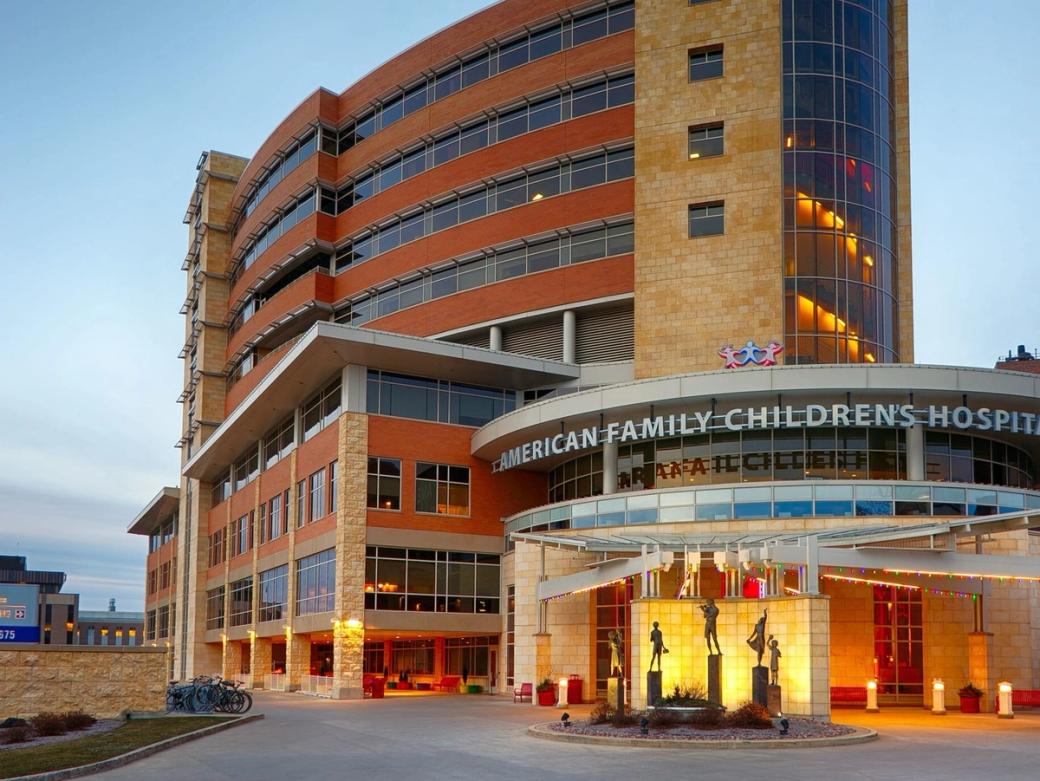 A multi-story round building with a sign reading "American Family Children's Hospital."