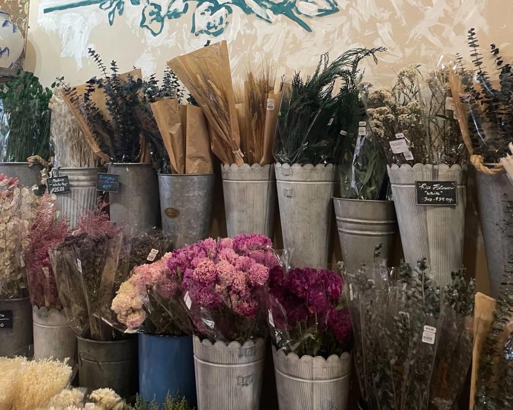 Metal buckets full of flowers.
