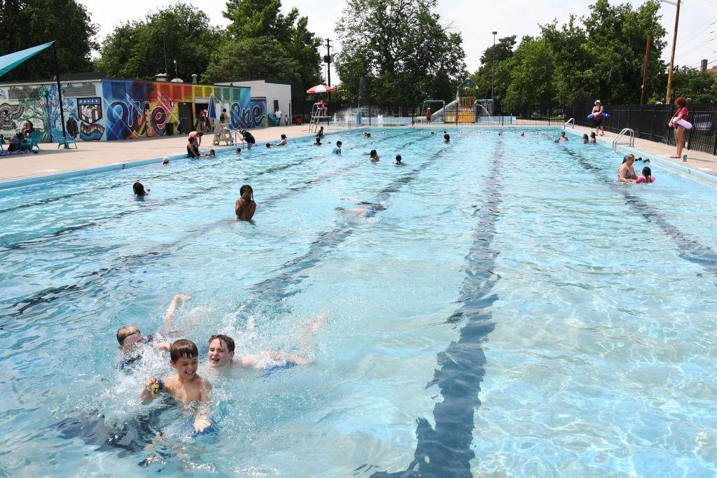 Residents enjoying a public pool in Denver
