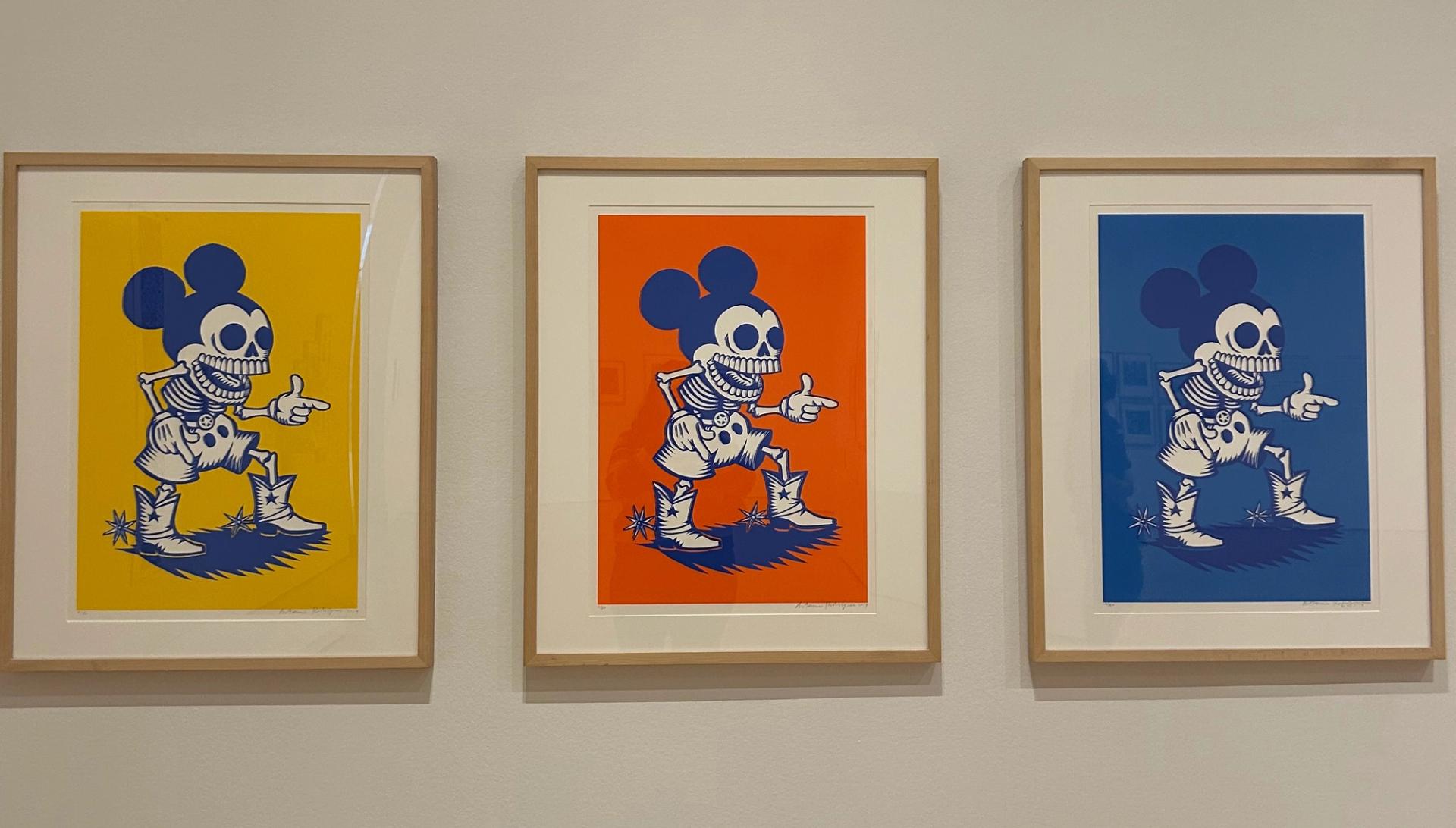 Three paintings of Mickey Mouse as a skeleton.