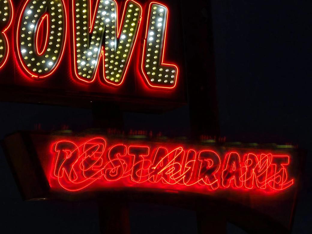 A neon sign that says "Bowl Restaurant"