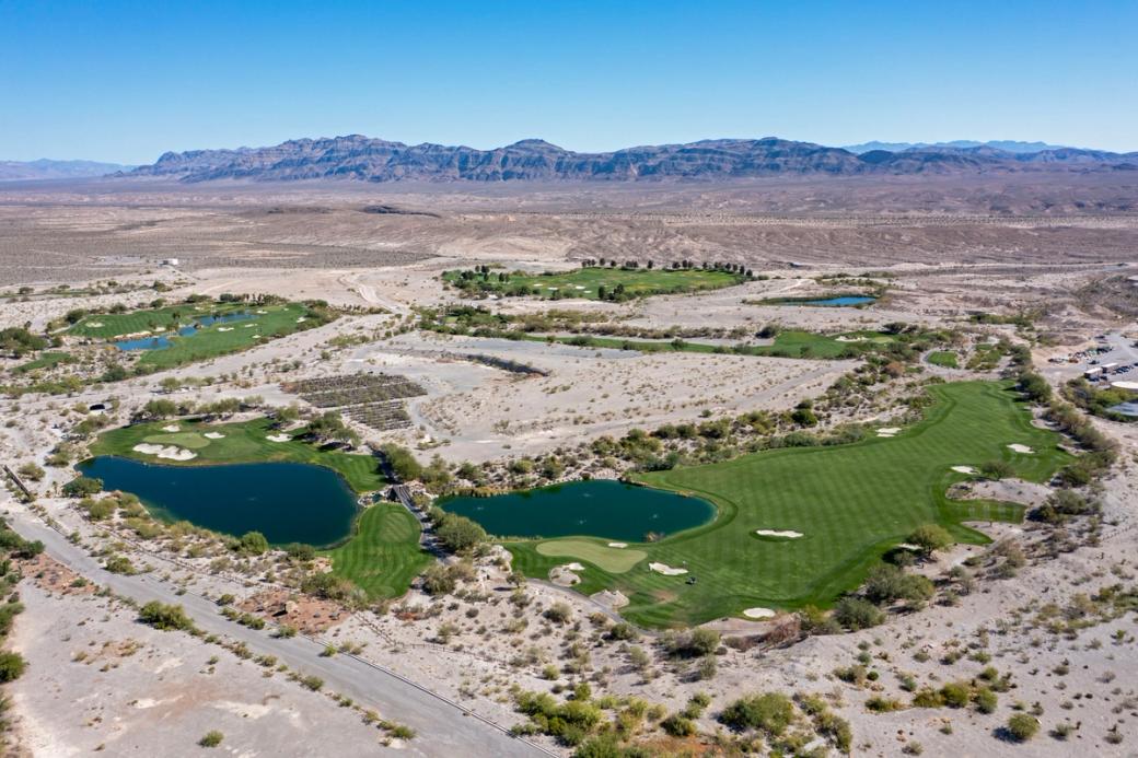 An aerial view of a golf course in the desert.