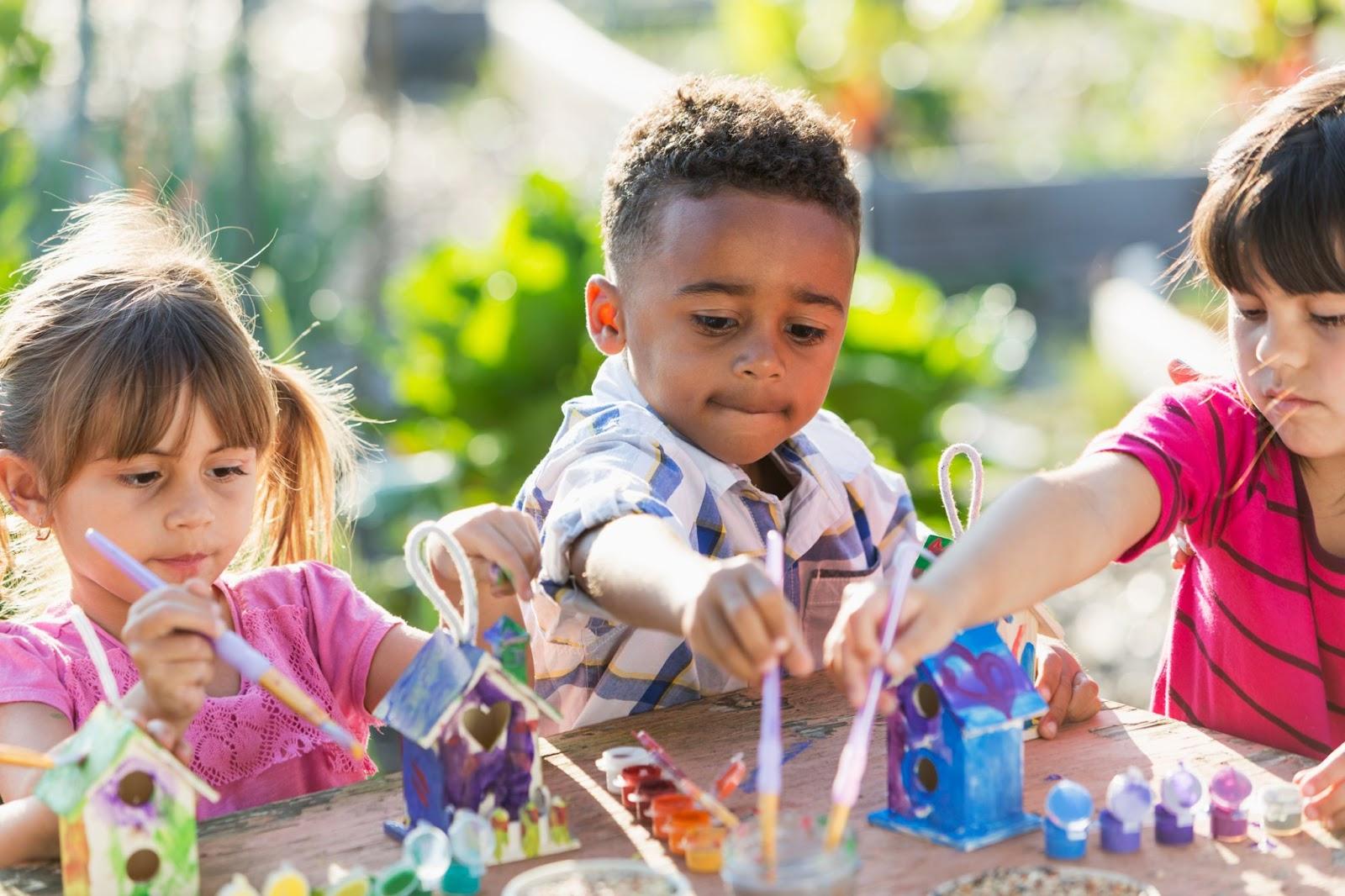 kids painting bird houses