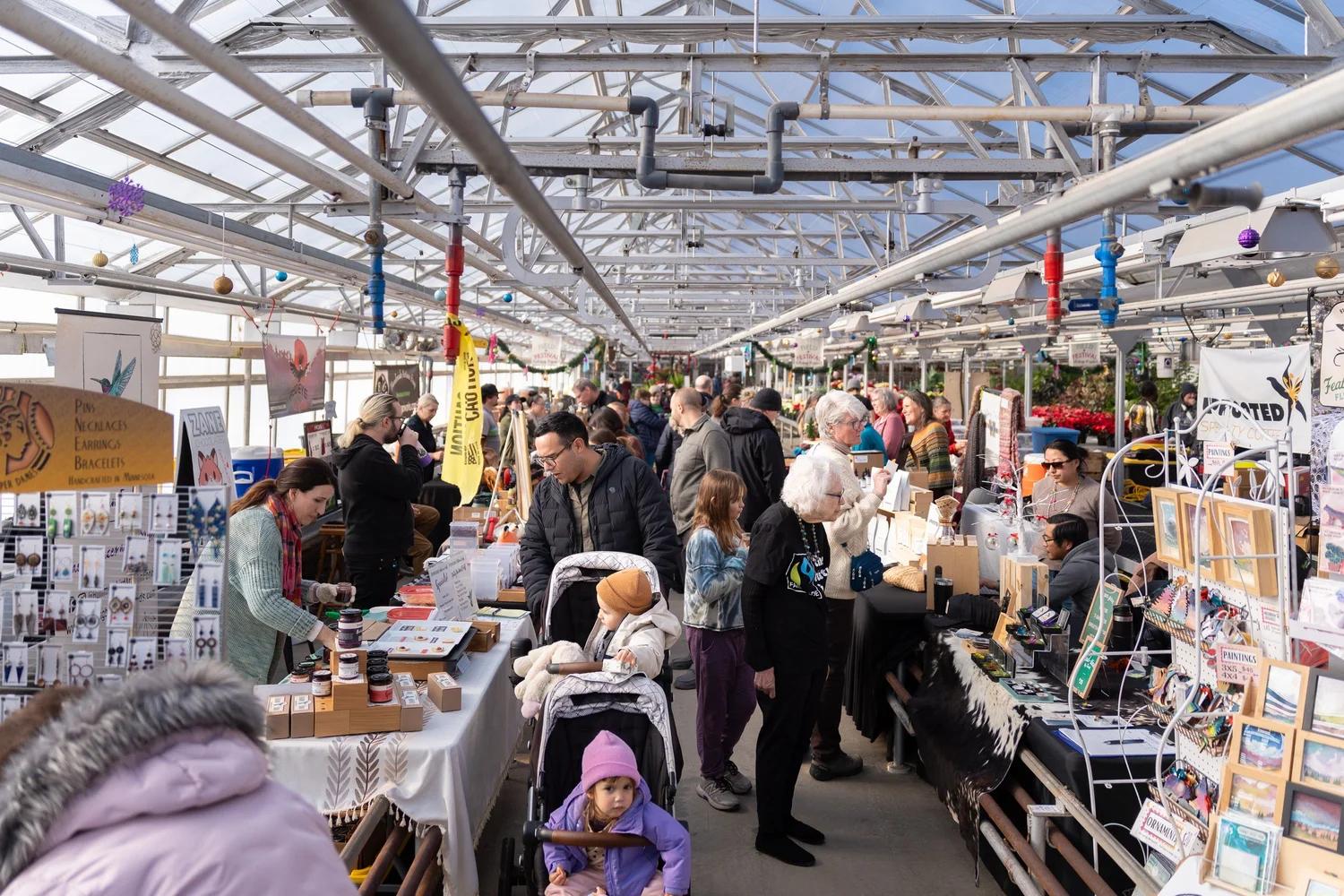 A crowd of shoppers at The Field and Festival holiday market at Wagner’s Garden Center in Minneapo