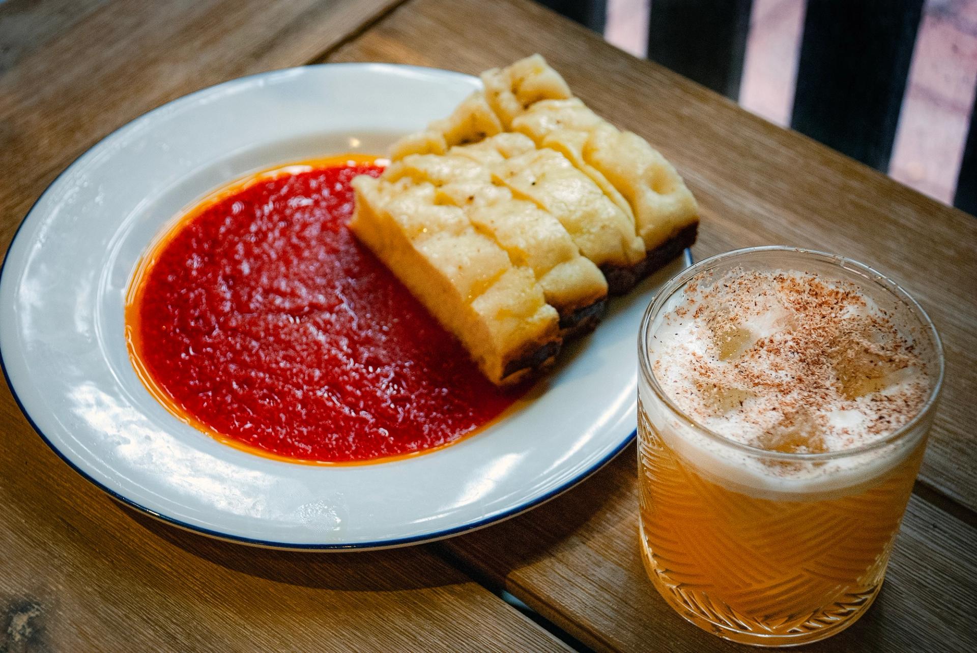 Tonari’s 'Cotton Bird' cocktail and spicy tomato oil dip with warm pizza bread.