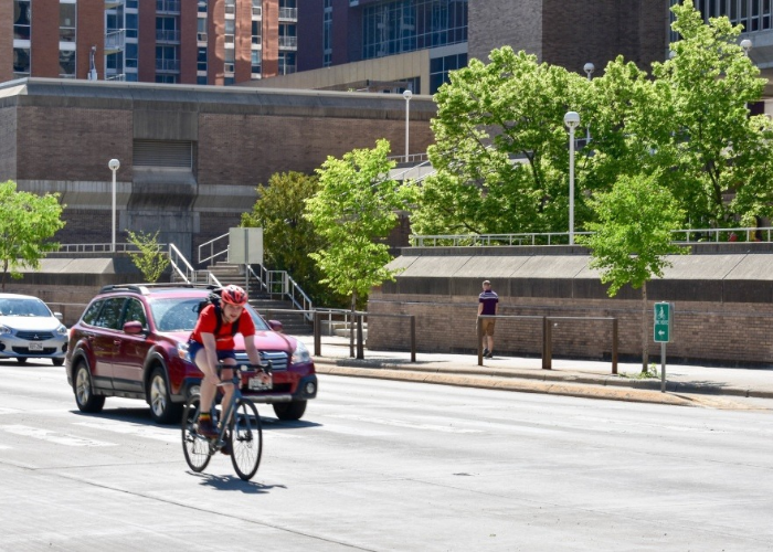 A cyclist rides on a downtown street.