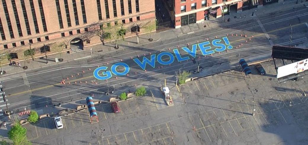 Road with "Go Wolves!" painted on it, viewed from high above