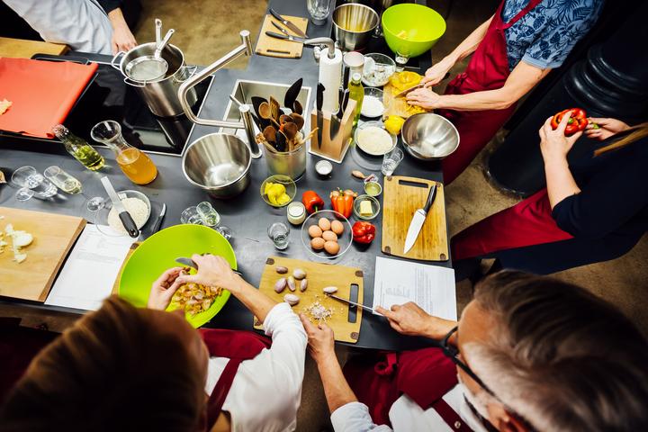 Overhead shot of members of a cooking class preparing food