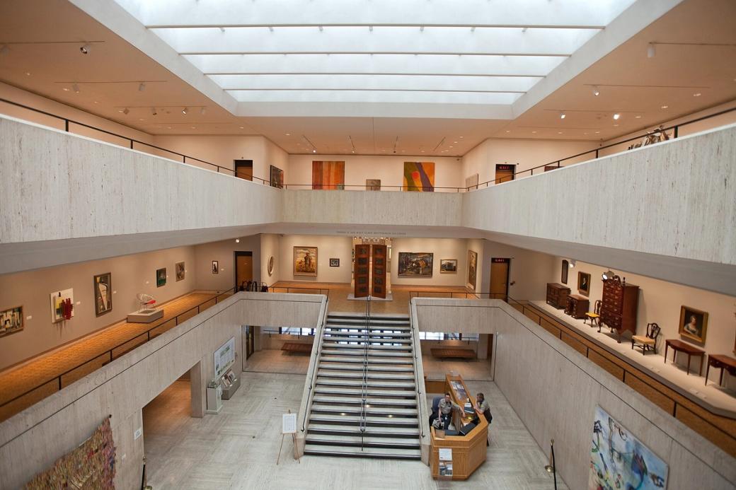 A museum interior with paintings on the walls.