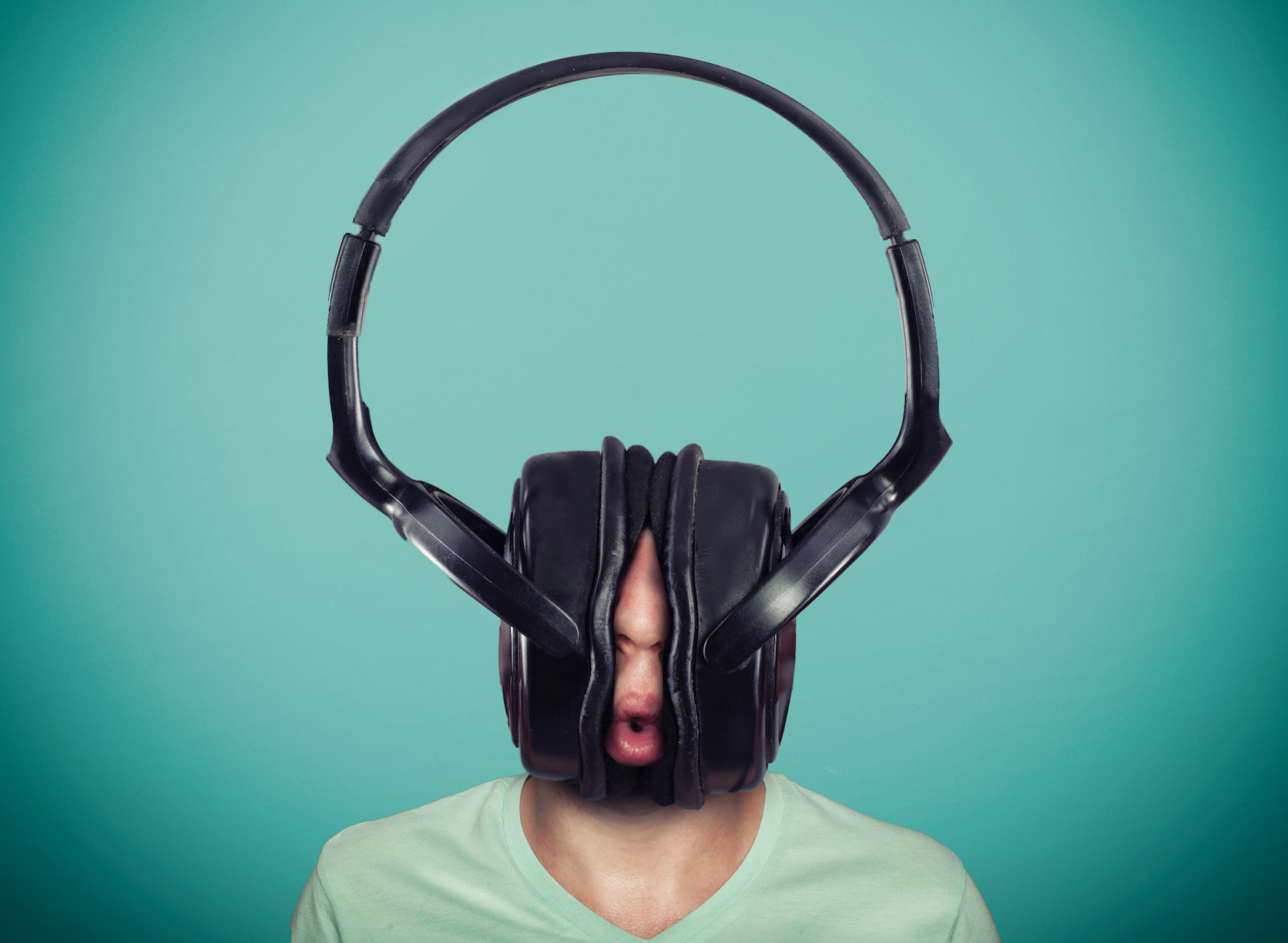 Photo of man wearing comically large headphones.