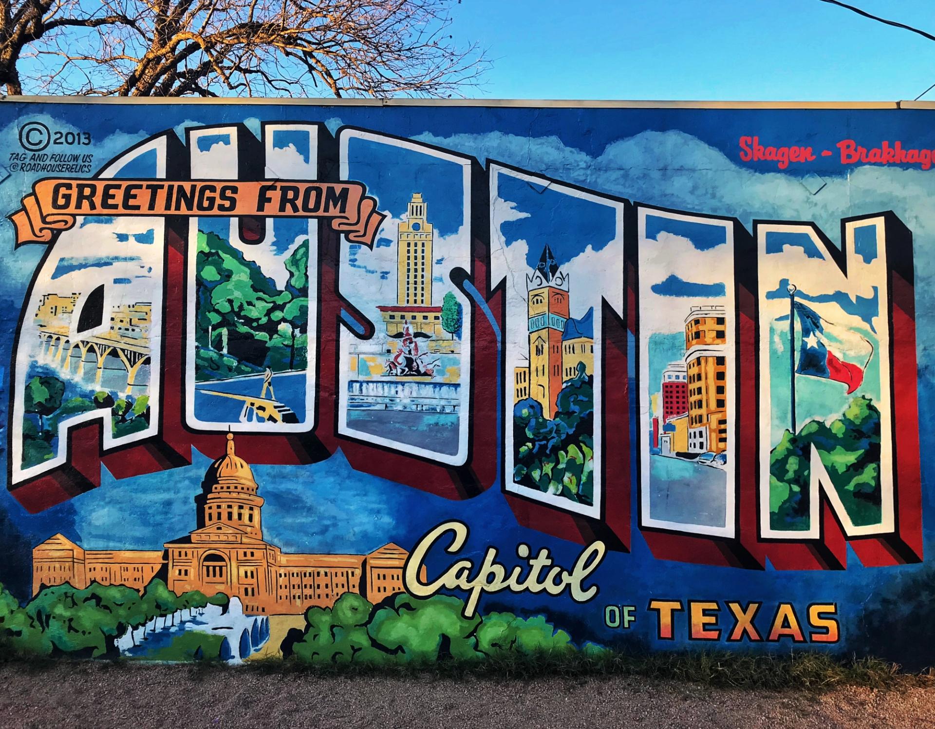 A colorful mural that says "Greetings from Austin, Capitol of Texas."