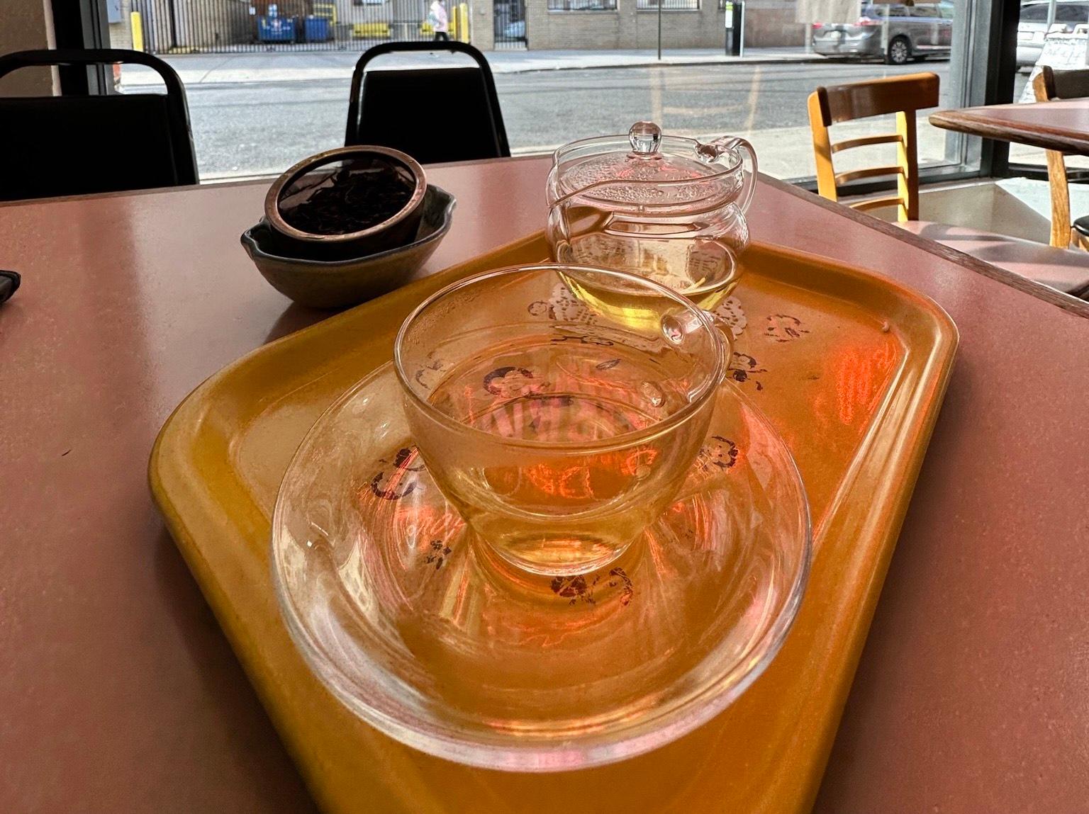 A tray with a teacup and teapot.
