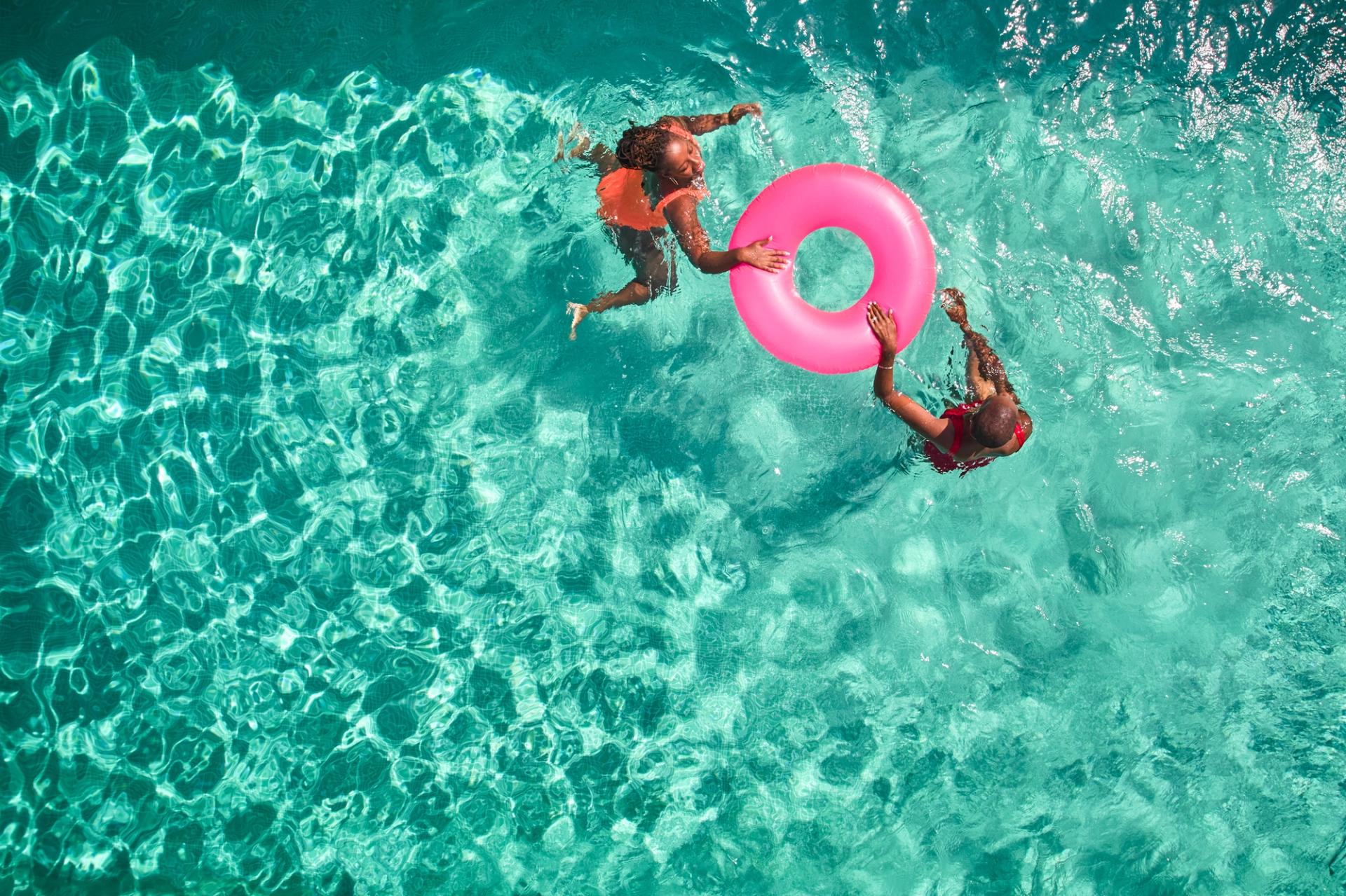 An overhead shot of two people floating in water