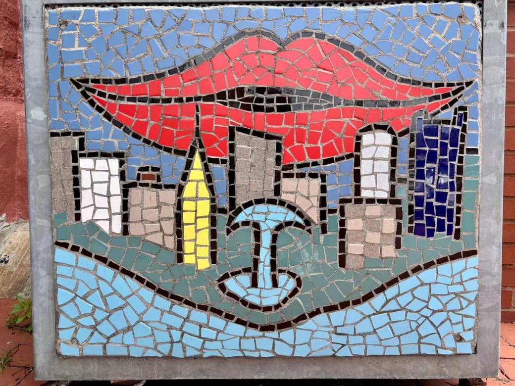 a mosaic mural of the point fountain, Downtown skyline, and red lips behind it