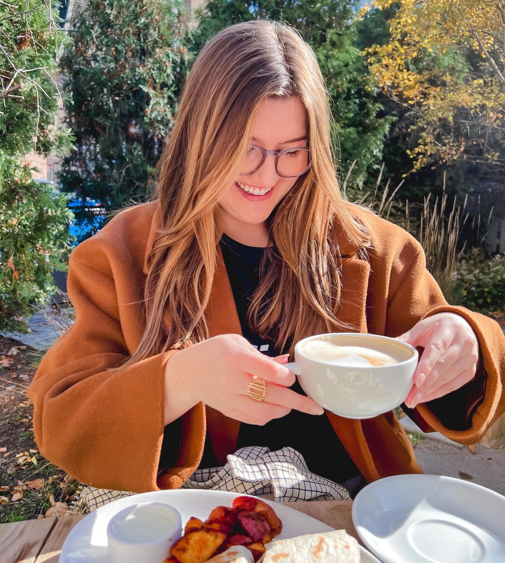 North Sider and Cuppa Chicago creator Hannah Kopach poses with a cup of coffee.