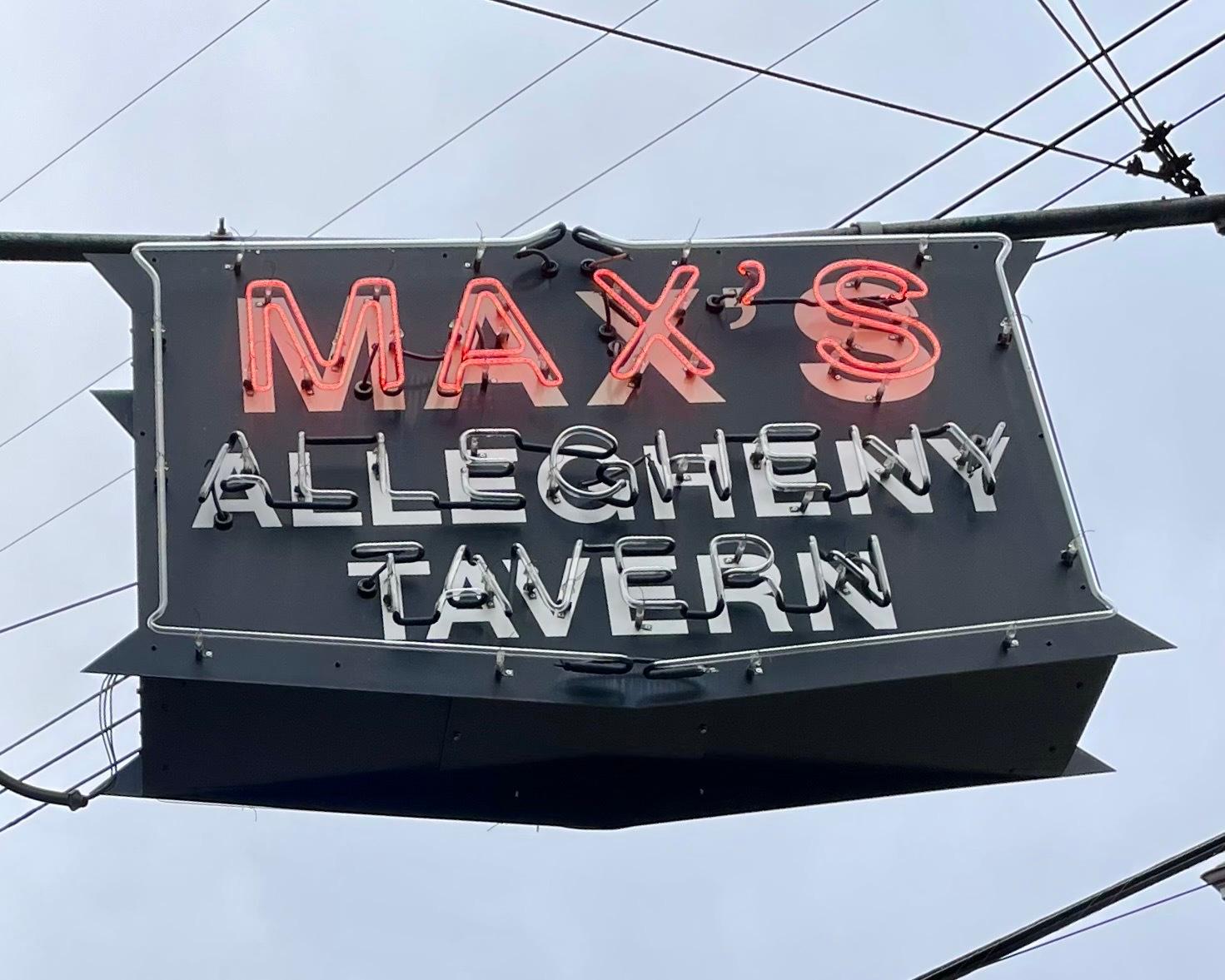 a business sign with red lit-up lettings reading "Max's Allegheny Tavern"