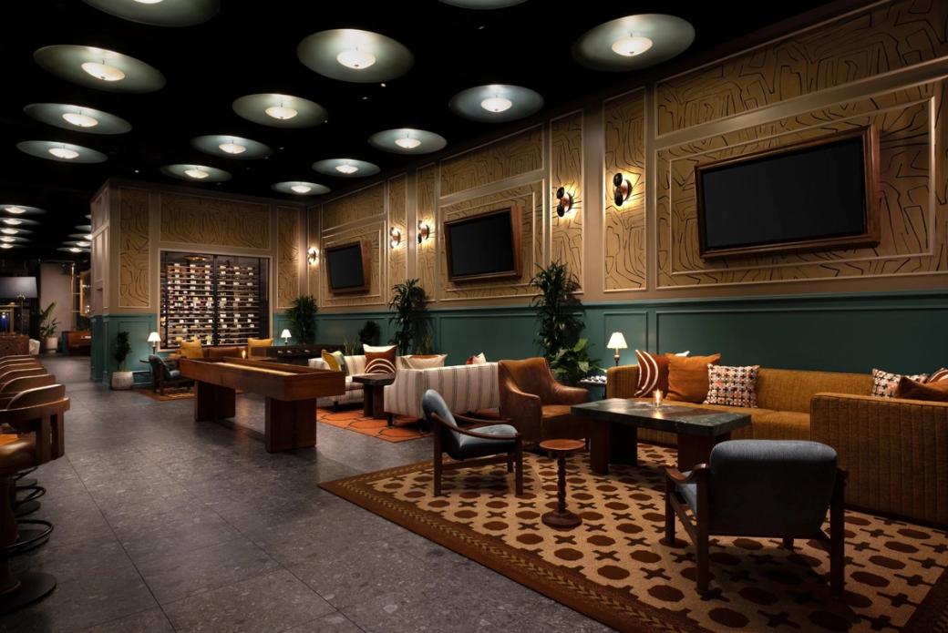 The interior of Hearthstone & Cellar. Couches and chairs are arranged in an open space with low lighting.