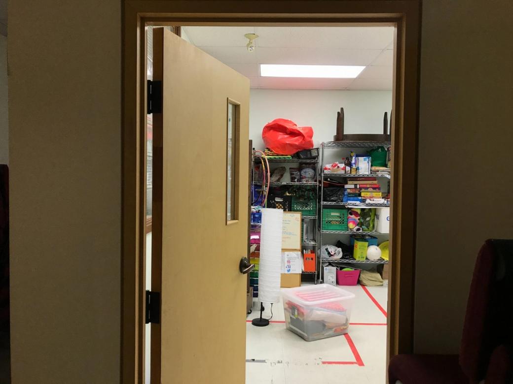 A door opens to a room full of school supplies.