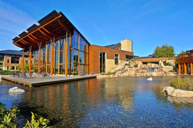 A wooden building sits on the water.