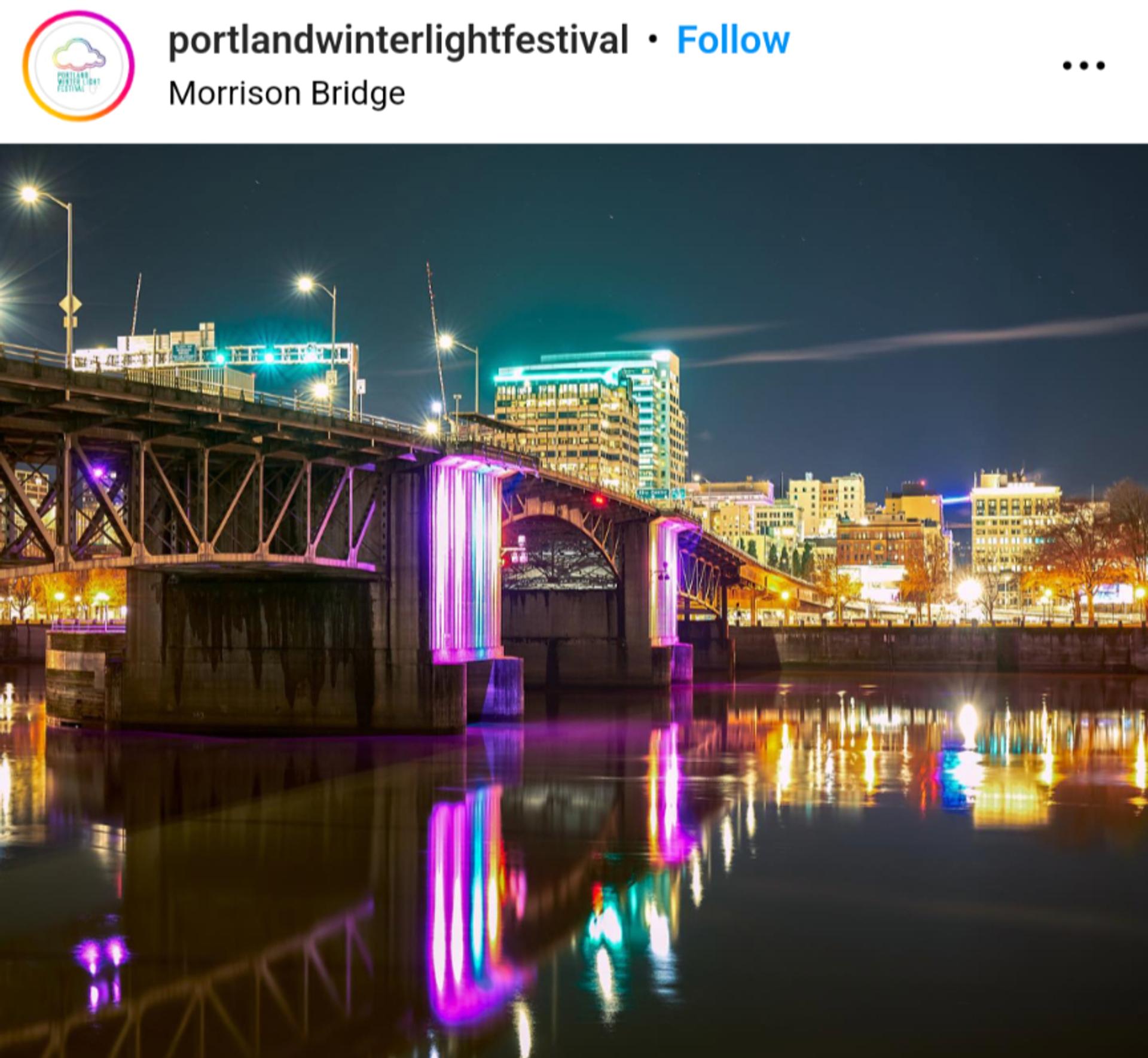The Morrison Bridge in pink, blue and white, with the Portland skyline all lit up