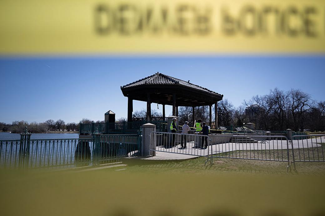 historic structure near lake after fire with police tape in the foreground.