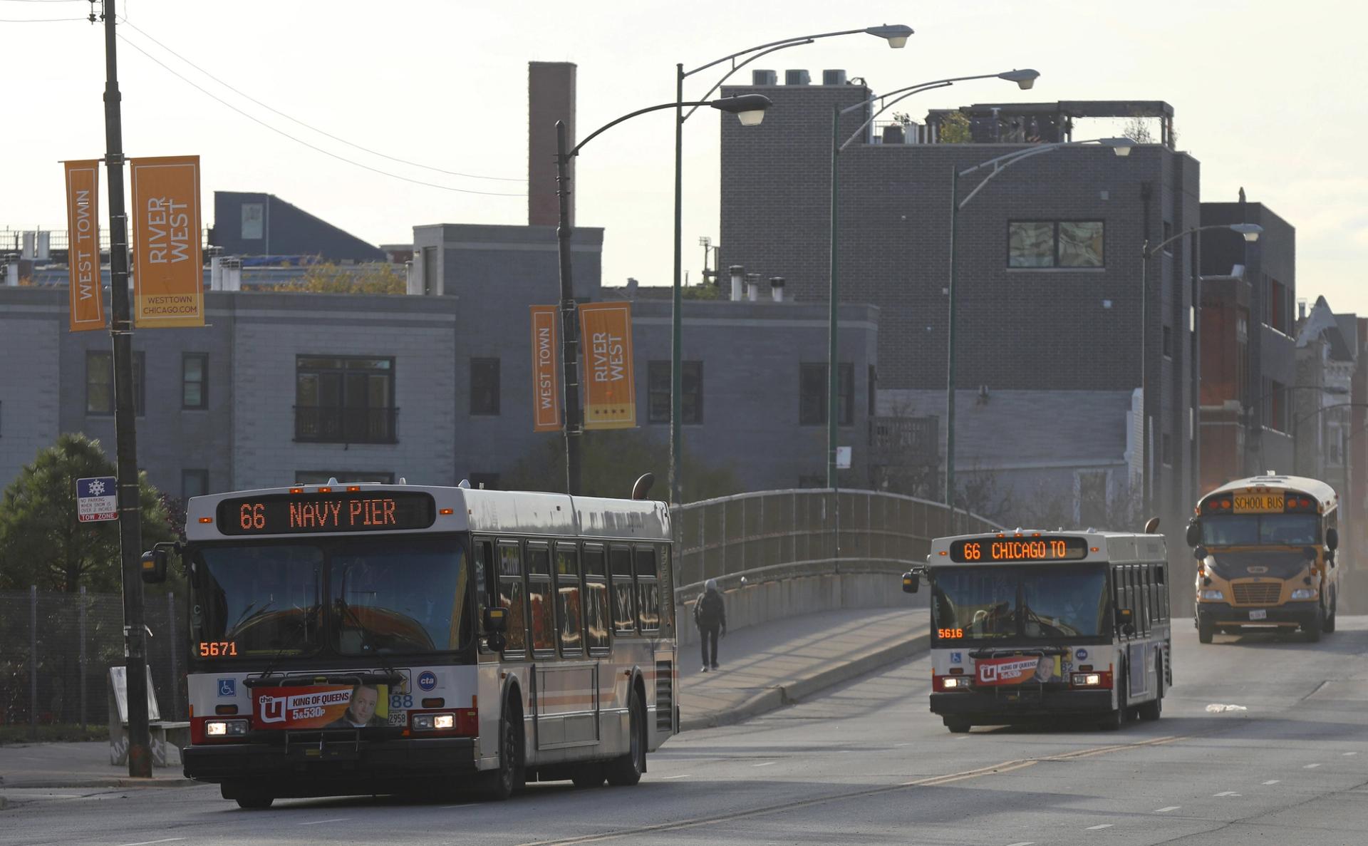 CTA buses approach a stop on Milwaukee Avenue.