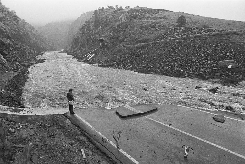A person surveys damage after a major Colorado flood