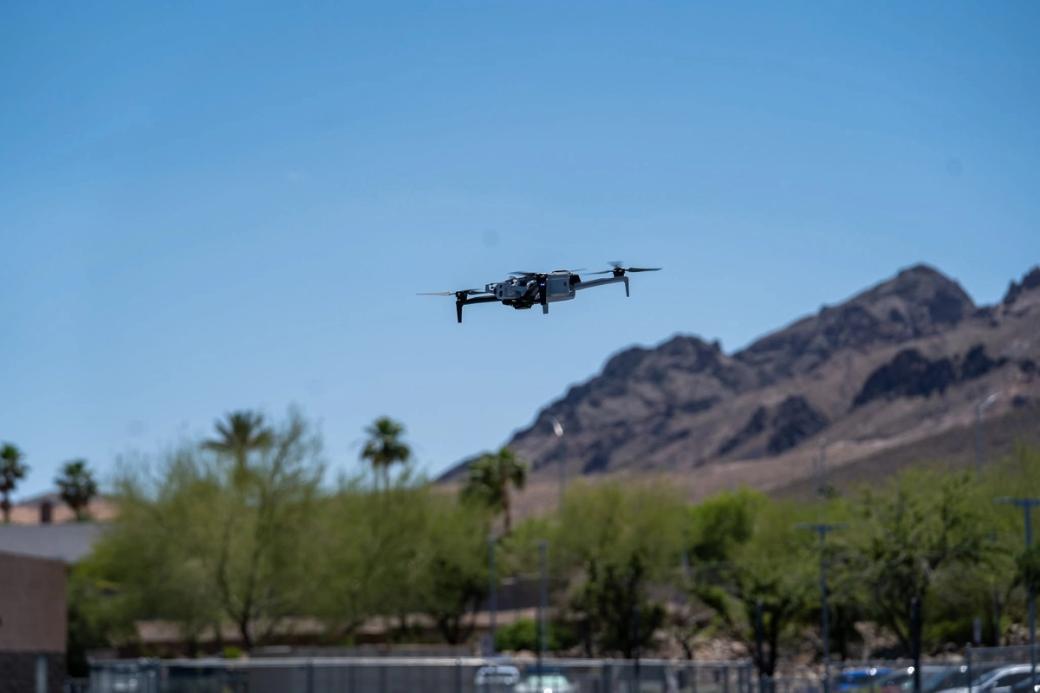 A drone flies over the desert.