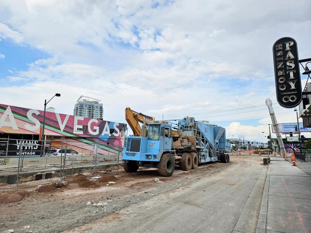 A large blue truck is part of a large road work project.