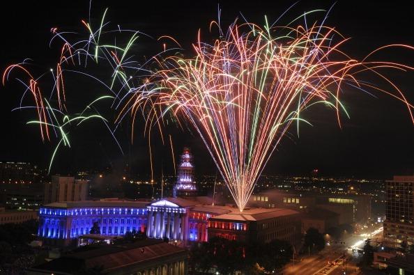 Bright fireworks shoot up from Denver’s City and County Building.