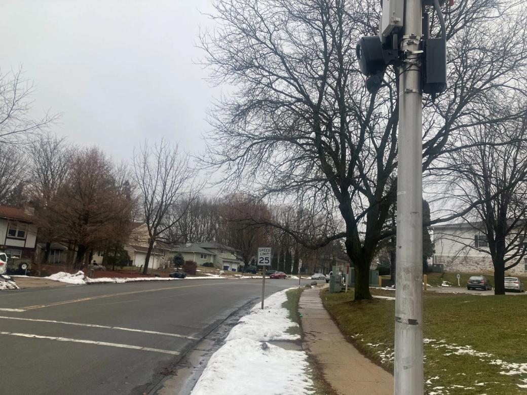 A flock camera mounted to a pole on a Madison street in the winter.