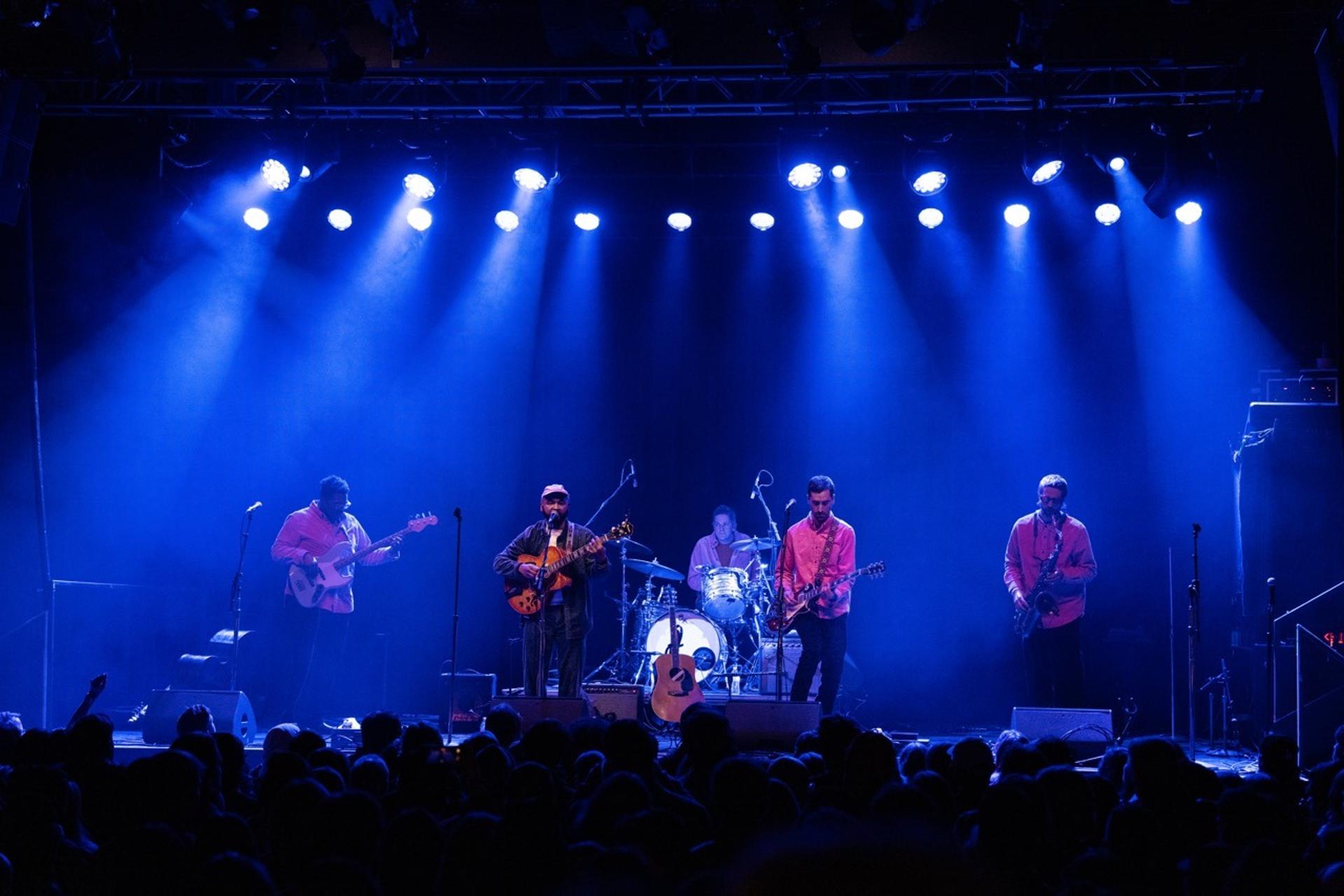 a group of people playing instruments on stage
