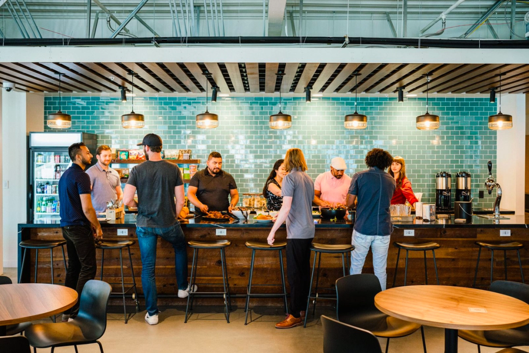 People working at The Shop Workspace in a shared area.