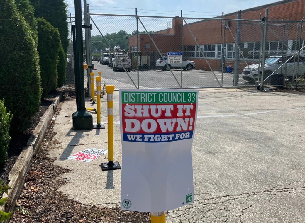 A sign that reads "District Council 33 Shut it down! We fight for:"