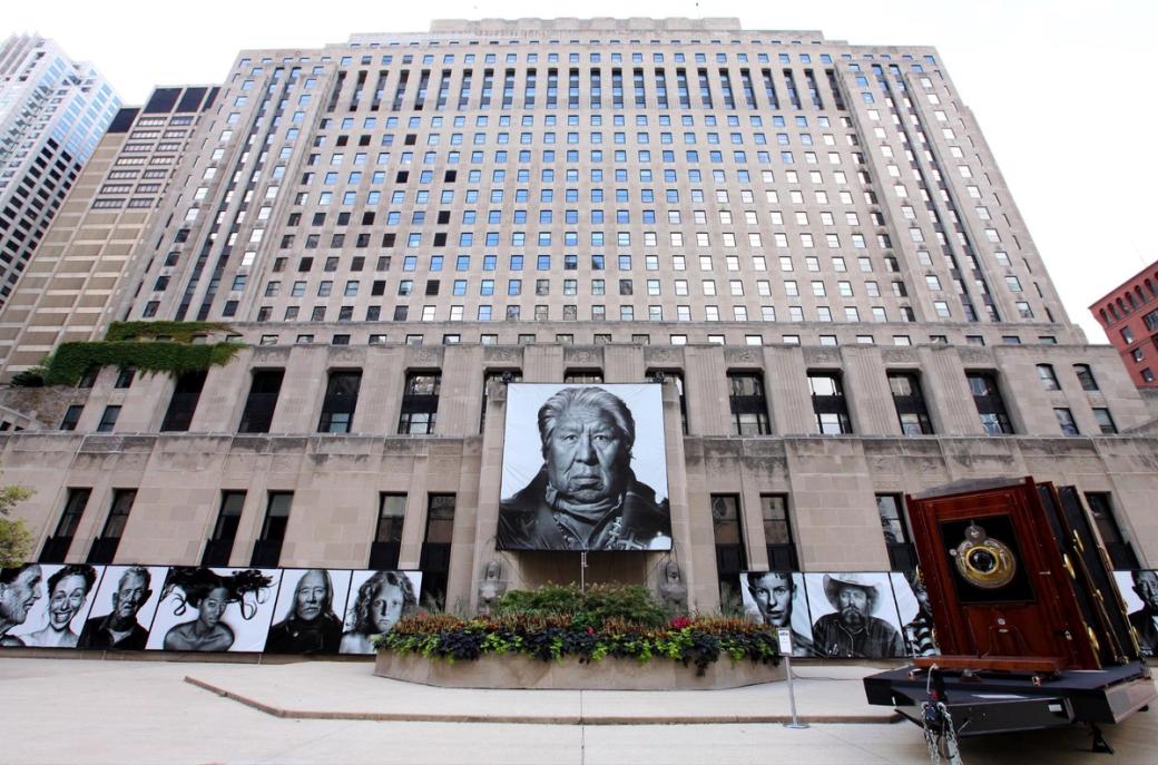 A large building with an assortment of very large photographs on the front