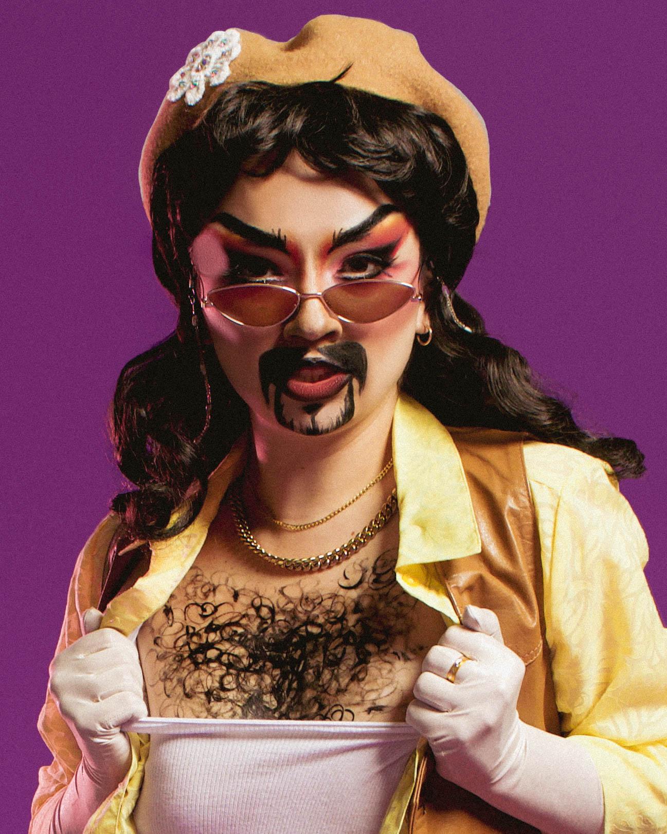 A headshot of a drag king with sunglasses and his chest hair poking out