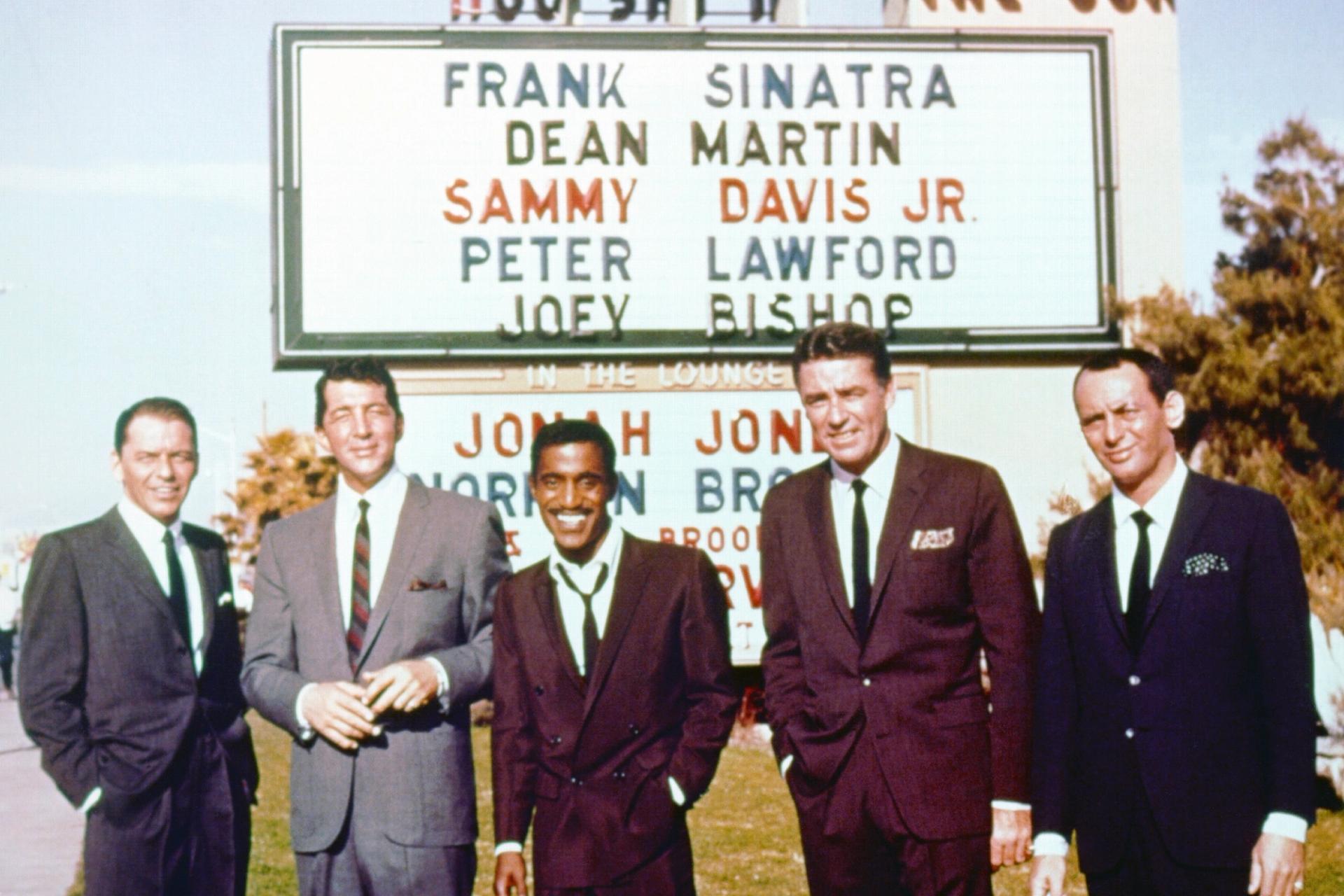 The Rat Pack stands in front of the Sands marquee in Las Vegas.