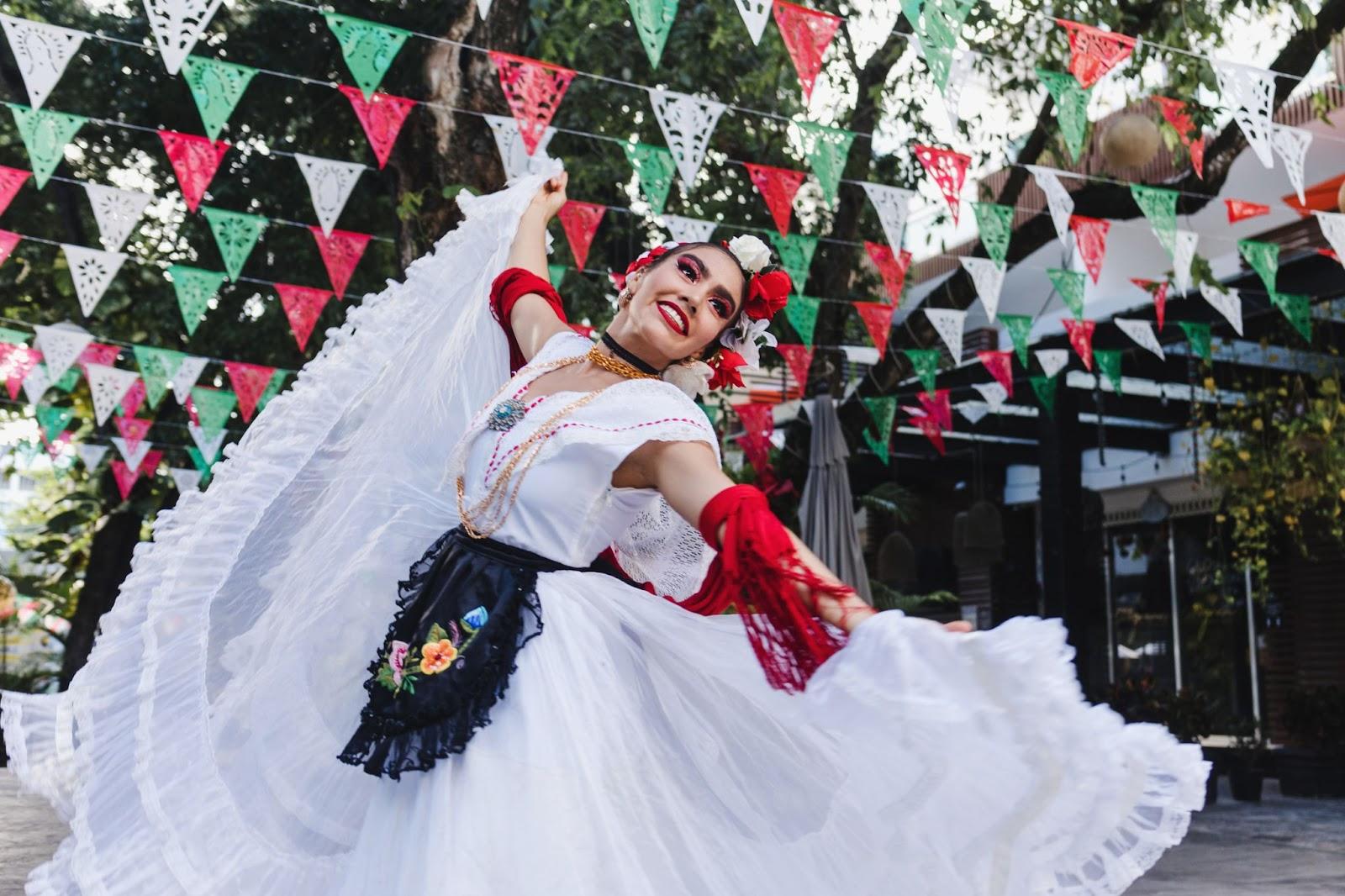 a woman in a traditional Mexican dress dances