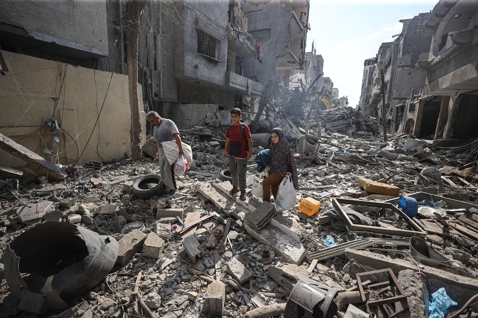 Palestinians search for their belongings among the rubble of their destroyed houses in Gaza City on Oct. 16.