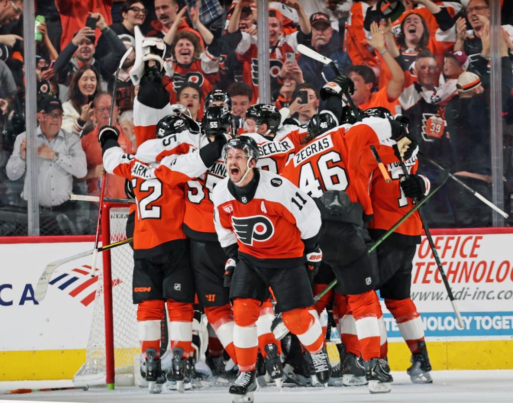 Philadelphia Flyers player huddle in celebration