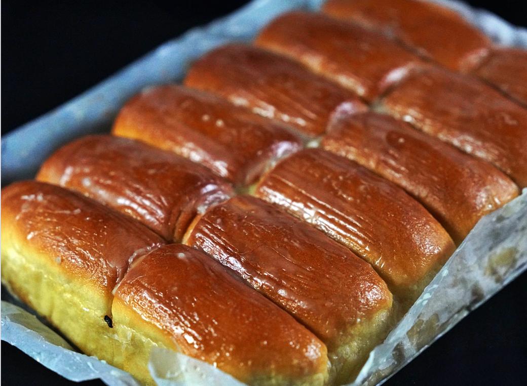 Buttered rolls in a pan.