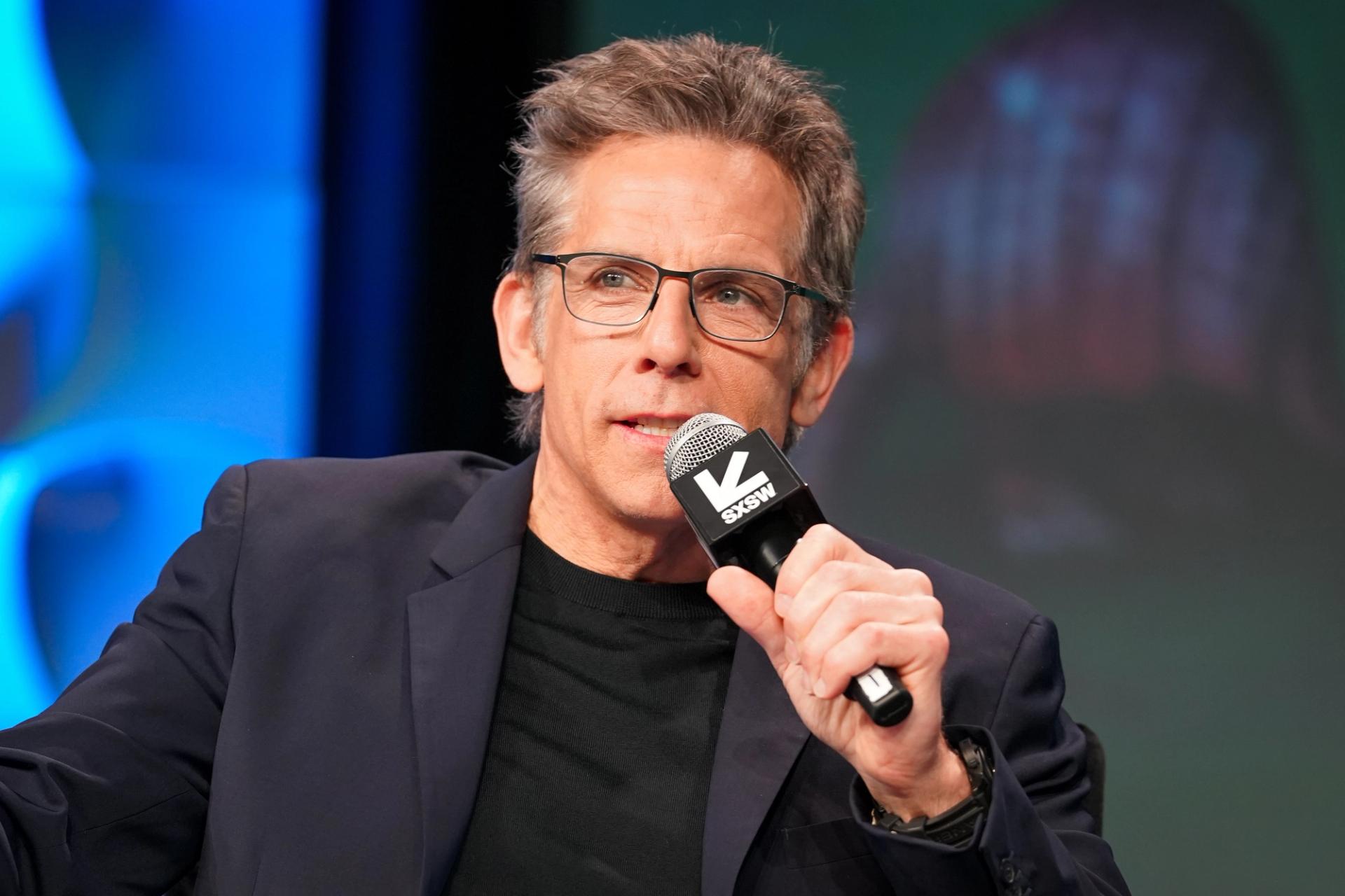 Ben Stiller holding a microphone.