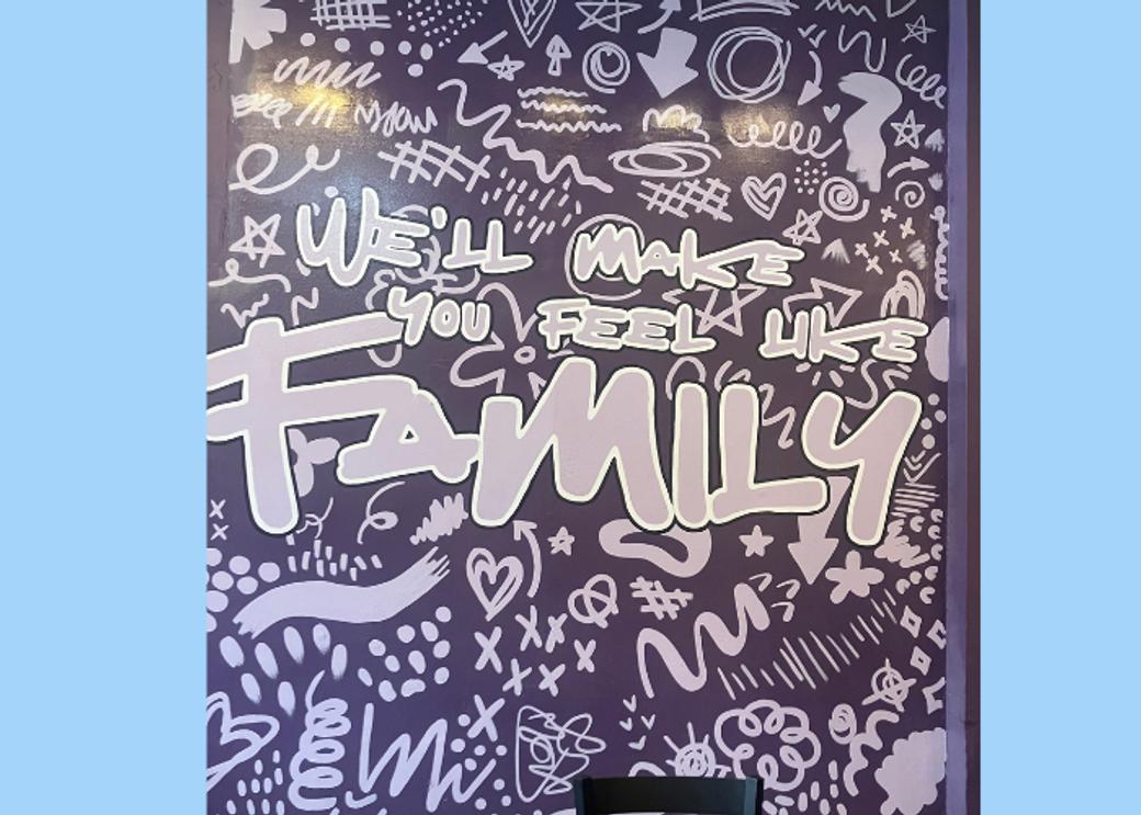 A mural with lots of writing. The word "FAMILY" is in the center.