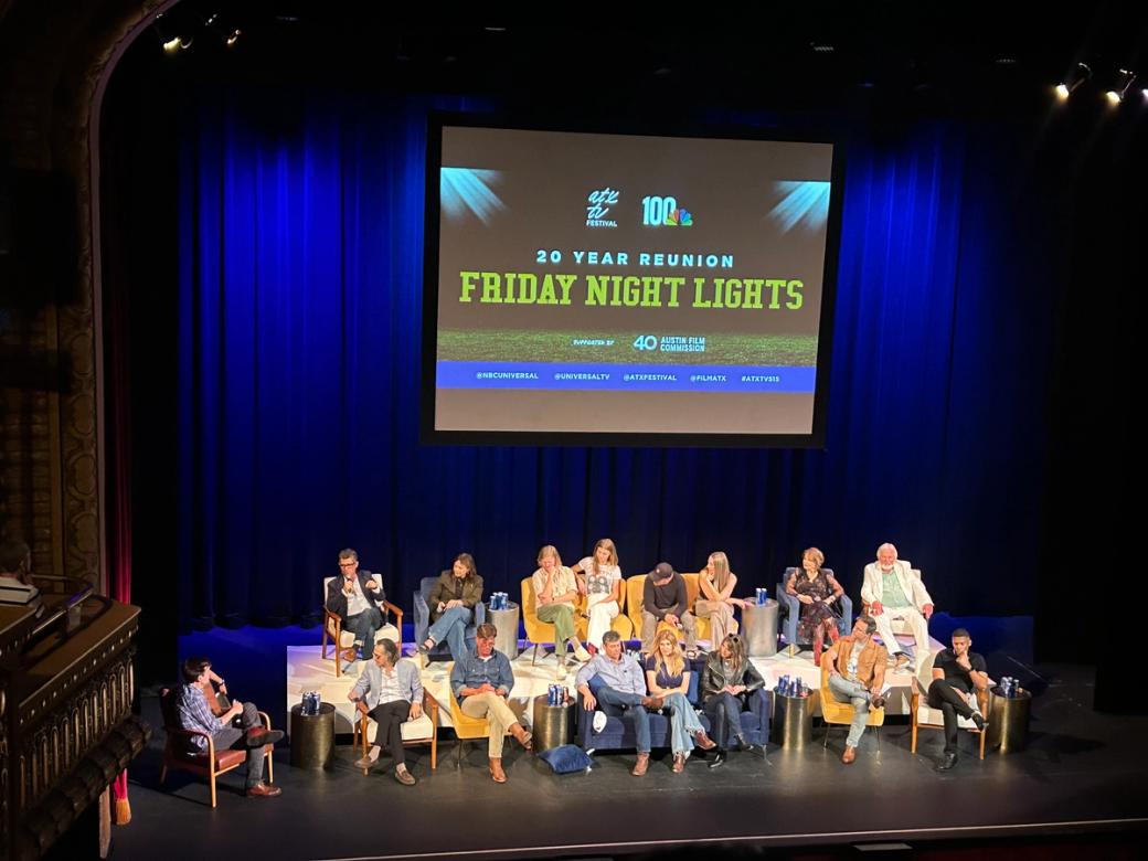 A group of people sitting on a stage.
