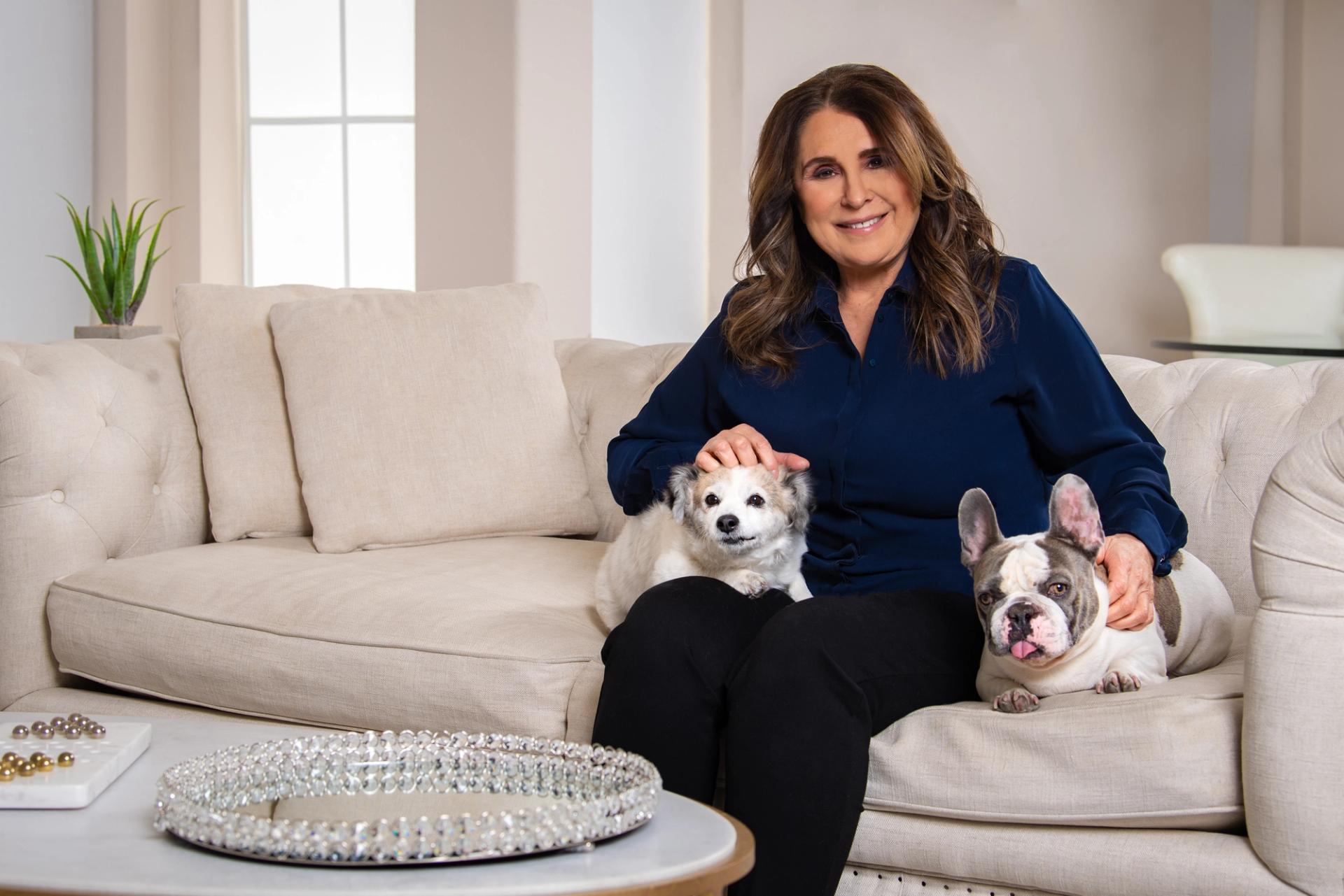 Victoria Seaman sitting on a couch with her dogs.