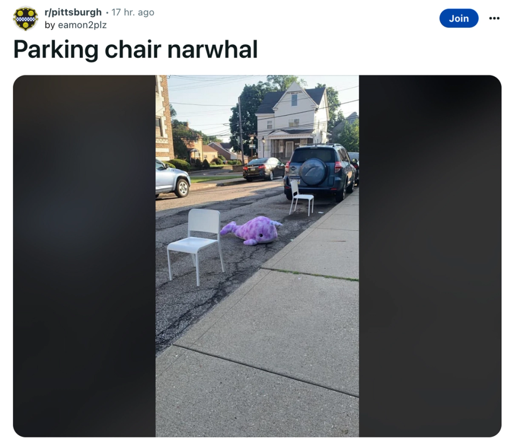 A stuffed narwhal used as a parking chair. (@eamon2plz on Reddit)