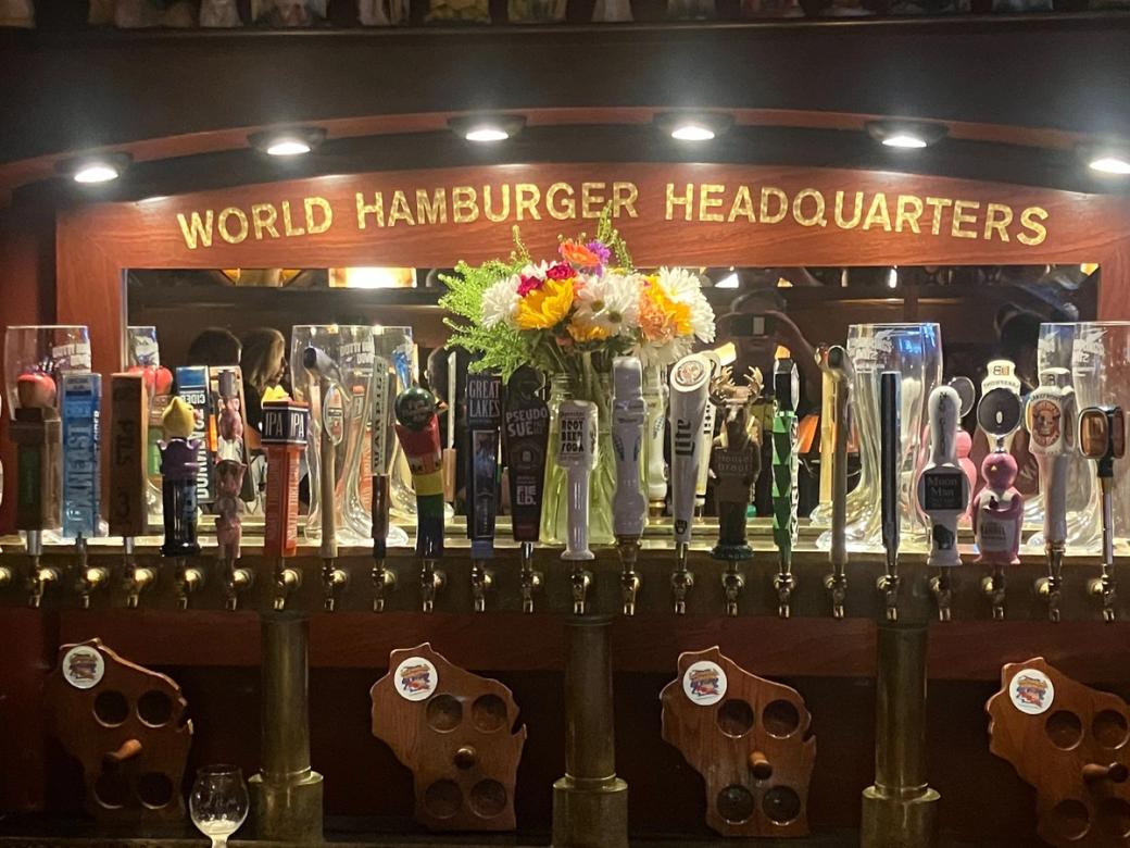 A sign behind a bar reads "World Hamburger Headquarters".