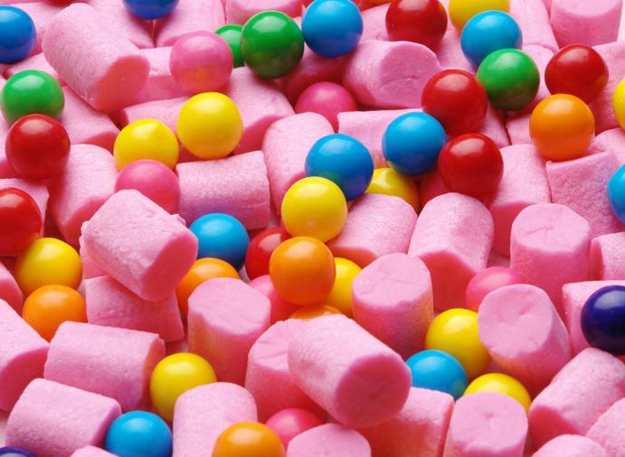 pink cylindrical shaped bubble gum, mixed in with multi-colored balls of bubble gum.